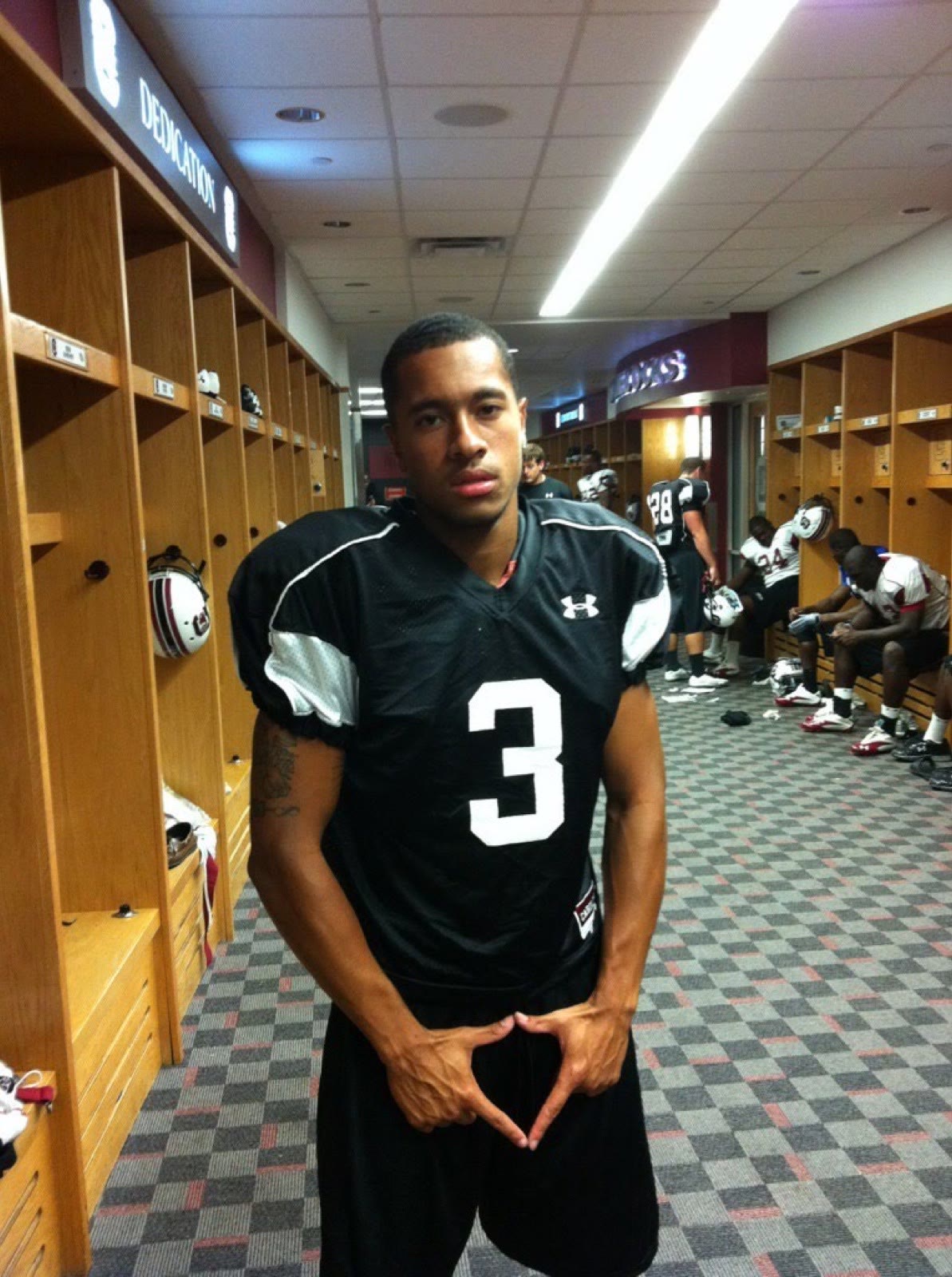 Ben Harvey in a South Carolina football jersey in the locker room
