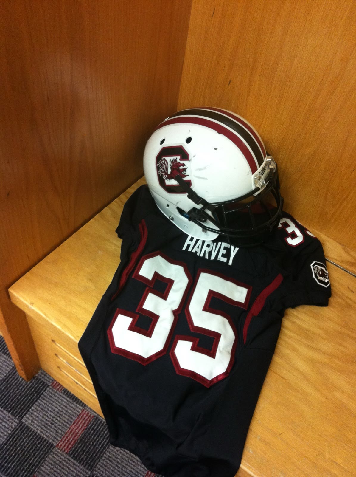 South Carolina Gamecocks jersey reading HARVEY 35 with helmet in a locker